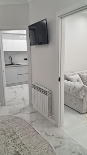 a living room with a television on a wall at AIRPORT&APARTMENT&parking in Chişinău