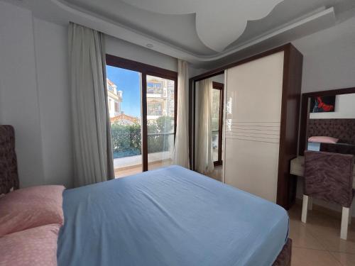 a bedroom with a bed and a large window at Sharm Hills Resort - 2Bedroom with Pool View and Beach Access in Sharm El Sheikh