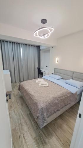 a bedroom with a large bed and a desk at AIRPORT&APARTMENT&parking in Chişinău