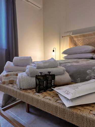 a pile of towels sitting on top of a bed at Villa Sveva in Làconi