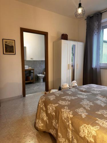 a bedroom with a bed and a bathroom with a sink at Villa Sveva in Làconi