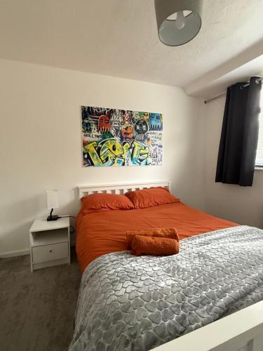 a bedroom with a bed and a painting on the wall at Families and Contractors Dudley DY1 in Lower Gornal
