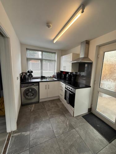 a kitchen with a stove and a dishwasher at Families and Contractors Dudley DY1 in Lower Gornal
