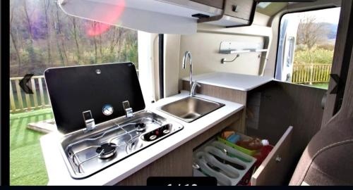 a kitchen in an rv with a sink and a sink at Camper La Palma fianza 600eu in Santa Cruz de la Palma
