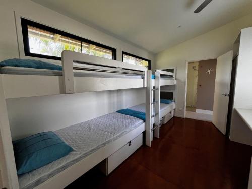 a room with three bunk beds in it at Rainbow North - Rainbow Beach in Rainbow Beach