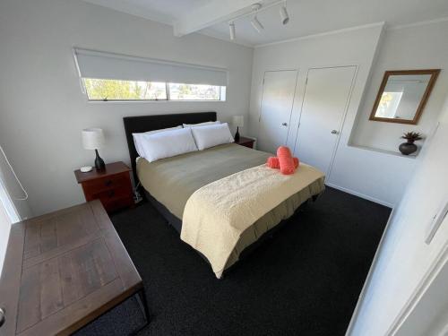 a small bedroom with a bed and a window at Home away from Home in Hamilton
