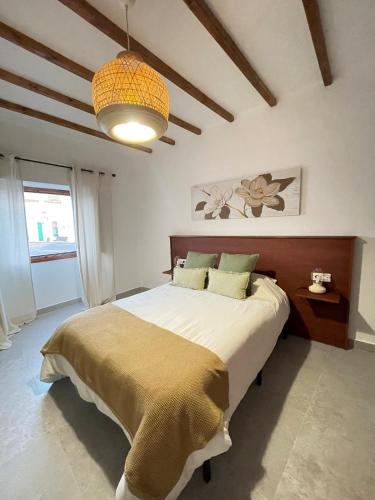 a bedroom with a large bed and a ceiling at Casa Tere in Teguise