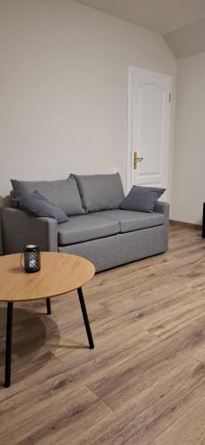 a living room with a couch and a coffee table at Lux GUEST HOUSЕ МUKACHEVO in Mukacheve