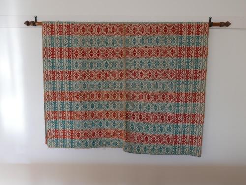 a striped shower curtain hanging on a wall at Lekanders Bär & Boende in Tyfta