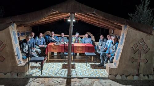 a large group of people sitting at a table at Maggaman Guest House in Tafraoute Sidi Ali