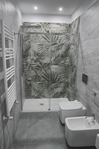 a bathroom with a shower and a toilet and a sink at Affittacamere ONE in Frascineto
