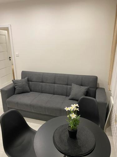 a living room with a couch and a table at Charming One Bedroom Apartment in Nové Zámky