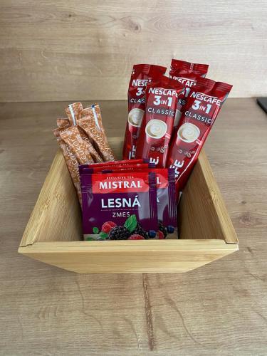 a wooden box with some snacks and crackers in it at Charming One Bedroom Apartment in Nové Zámky
