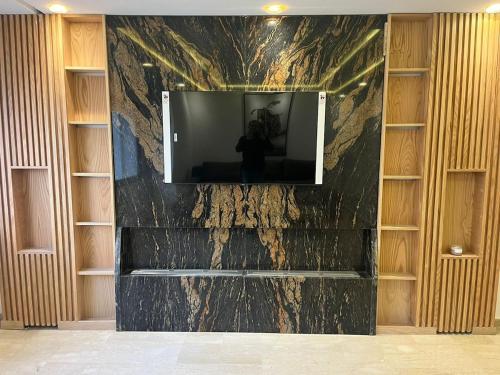a television on a wall in a room at downtown luxurious flat quartier Gauthier in Casablanca