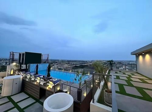 a balcony with a swimming pool on top of a building at SkyLuxe Studio 2 with rooftop Pool & Self Check In in Islamabad