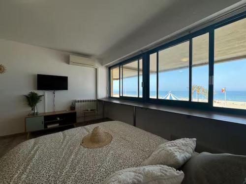 une chambre avec un lit avec un chapeau dessus dans l'établissement Le refuge marin - Canet - front de mer, à Canet