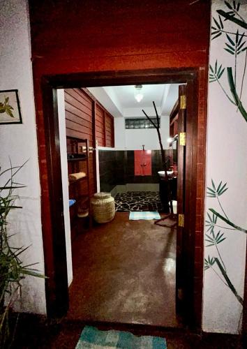 an open door into a room with a hallway at Appartement ATIALA in Hell-Ville