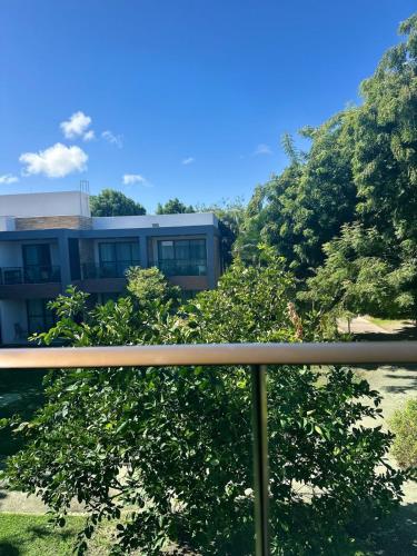 a building with trees in front of it at Apartamento no Iloa Residence - Com Enxoval Completo in Barra de São Miguel