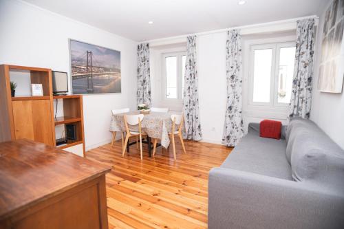 a living room with a couch and a table at My Mouraria Suites in Lisbon