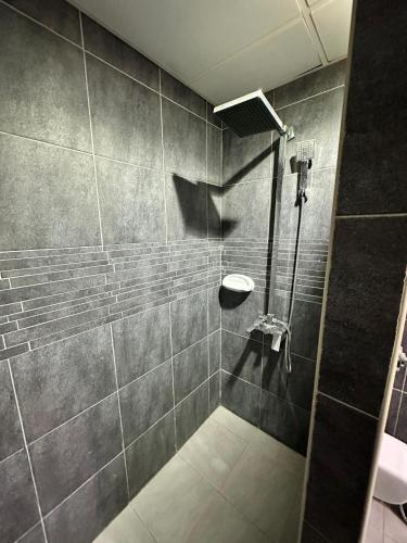 a bathroom with a shower with a sink at International Abu-Dhabi Hostel Villa in Abu Dhabi