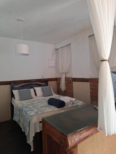 a bedroom with a large bed and a window at Chalé do lago Ladeira de Pedra in Salesópolis