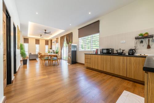a kitchen and living room with a hard wood floor at La Ferringhi Villa - Tropical Collection, by ALV in Batu Ferringhi