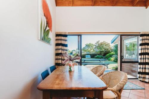 a dining room with a wooden table and chairs at Lovely Pet Friendly Townhouse in Methven