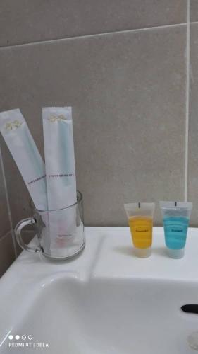 three cups sitting on top of a counter at FDhomestay in Kampung Baharu Batu Dua