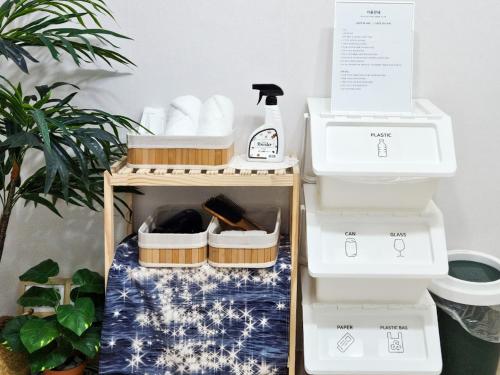 a shelf with towels and a toilet in a room at Stay Toseong in Busan