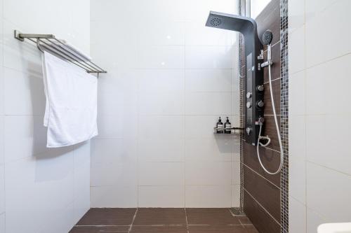 a bathroom with a shower with a glass door at La Ferringhi Villa - Tropical Collection, by ALV in Batu Ferringhi