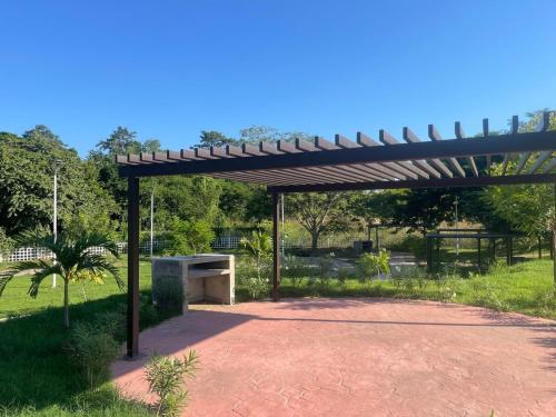 a wooden pergola in the middle of a park at FW Peninsula Rental in Puerto Vallarta