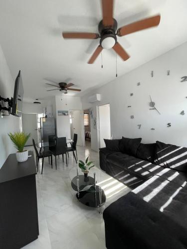 a living room with a couch and a ceiling fan at FW Peninsula Rental in Puerto Vallarta