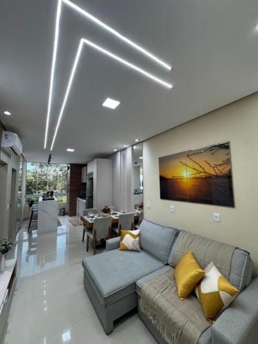 a living room with a couch and a table at Flat Novo Todo Climatizado em Alter do Chão in Alter do Chao