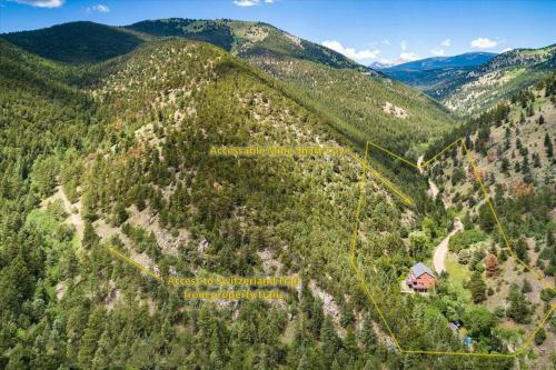 an aerial view of a mountain with a house on it at Boulder Luxury Getaway 7 acres River & Pond in Boulder