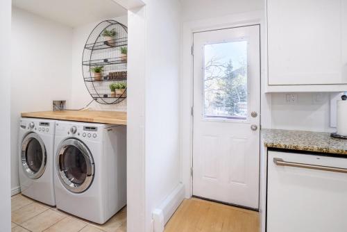 a white laundry room with a washer and dryer at Boulder Luxury Getaway 7 acres River & Pond in Boulder
