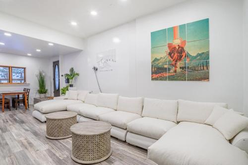 a living room with a white couch and a table at Boulder Luxury Getaway 7 acres River & Pond in Boulder
