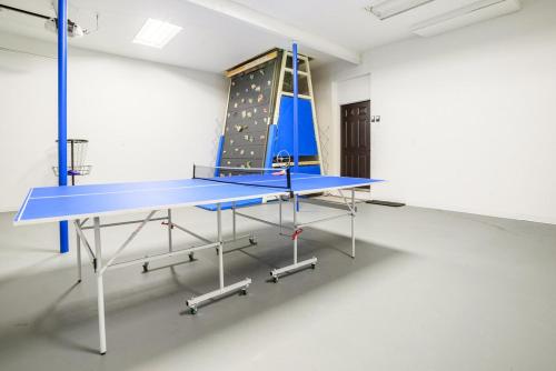 a blue ping pong table in a room at Boulder Luxury Getaway 7 acres River & Pond in Boulder