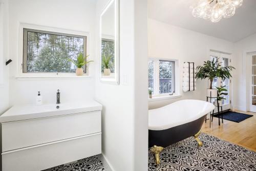 a white bathroom with a tub and a sink at Boulder Luxury Getaway 7 acres River & Pond in Boulder