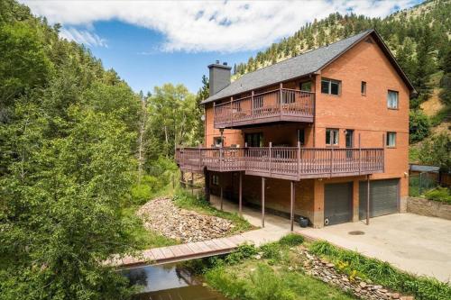 an aerial view of a large brick house with a balcony at Boulder Luxury Getaway 7 acres River & Pond in Boulder