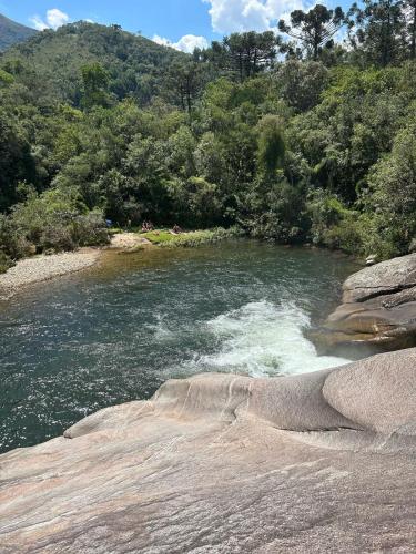 a river with rapids on top of it at Chalé pinheirinho in Itamonte