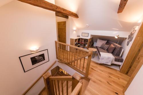 a spiral staircase leading up to a living room at Luxury Chalet Mallnitz in Mallnitz