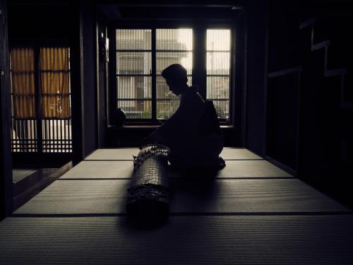 a man sitting in a room looking out the window at Kotone in Kanazawa