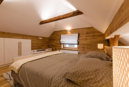 a bedroom with a bed in a room with wooden walls at Luxury Chalet Mallnitz in Mallnitz