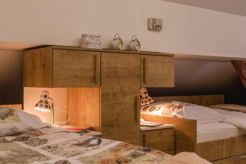a bedroom with two beds and a large wooden cabinet at Luxury Chalet Mallnitz in Mallnitz