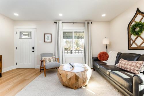 a living room with a couch and a coffee table at End Zone Escape - 2BR house 1 mile to ND Stadium! in South Bend