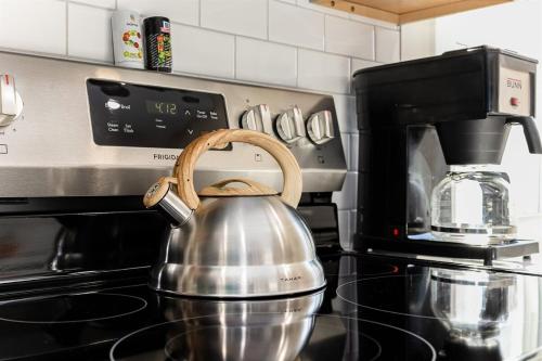 a tea kettle sitting on top of a stove at End Zone Escape - 2BR house 1 mile to ND Stadium! in South Bend