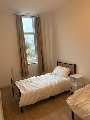a small bedroom with a bed and a window at The Lookout in Cove