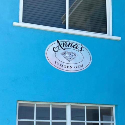 a sign on the side of a blue building at Anna's Hidden Gem Waterfront in Farmerʼs Hill