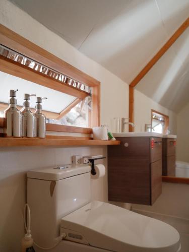 a bathroom with a toilet and a sink at Tantawan sea view residence 山海居 in Salad Beach