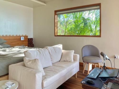 a living room with a couch and a window at Tantawan sea view residence 山海居 in Salad Beach